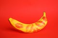 Fresh banana with lipstick marks on red background. sex concept