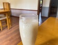 Fresh banana smoothies glass on wood table Royalty Free Stock Photo