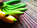 Fresh bananas green yellow on old brick background.