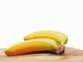 Fresh bananas on a wooden board and white background Royalty Free Stock Photo