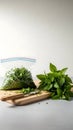 Fresh Basil Leaves Being Prepared for Storage in a Ziploc Bag on a Cutting Board Royalty Free Stock Photo
