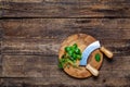 Fresh basil with mezzaluna cutting board