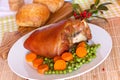 Fresh Bavarian roasted knuckle of pork with carrot Royalty Free Stock Photo