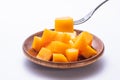 Fresh and beautiful mango in a wooden plate with sliced diced mango chunks isolated with white background, copy space