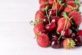 Fresh Beautiful Ripe Berries on a White Wooden Background Sweet Strawberries and Cherry Copy Space Close Up Royalty Free Stock Photo