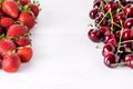 Fresh Beautiful Ripe Berries on a White Wooden Background Sweet Strawberries and Cherry Frame Copy Space Royalty Free Stock Photo