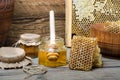 Fresh bee Honey in honeycombs and in a glass jar with a honey dipper on a wooden background Royalty Free Stock Photo