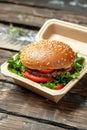 Fresh Beef Burger in Eco-Friendly Packaging on Wooden Table