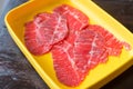 Fresh beef raw sliced was served for Sukiyaki and Shabu or Yakiniku   restaurant which it put on yellow plate Royalty Free Stock Photo