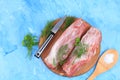 Fresh beef steak with ingredients for cooking on an old table, raw meat with dill, parsley, salt on a cutting wooden board,