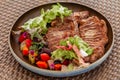 Grilled Chopped T-bone Steak Served with Salad and Vegetables on Beachfront Cafe