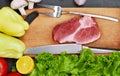 Fresh beef steak, wooden spoon, knife and Assortment of Fresh Vegetables, aromatic herbs, spices and vegetables for cooking , on r Royalty Free Stock Photo