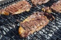 Fresh beef steaks being fried or prepared on grill or BBQ Royalty Free Stock Photo