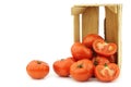 Fresh beef tomatoes and a cut one in a wooden crate Royalty Free Stock Photo