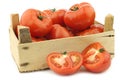 Fresh beef tomatoes and a cut one in a wooden crate Royalty Free Stock Photo