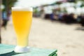 Fresh cold beer in a glass on a hot sunny day. fresh beer and beach Royalty Free Stock Photo