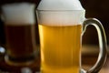 fresh beer with bubbles in a glass mug over dark wooden background in a pub or bar Royalty Free Stock Photo