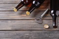 Fresh beer in glass bottles and opener on wooden background Royalty Free Stock Photo