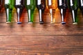 Fresh beer in glass bottles on wooden background Royalty Free Stock Photo