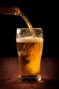 Fresh beer pouring from bottle into glass Royalty Free Stock Photo