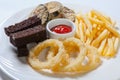 Fresh beer snacks assortment on a white plate. French fries, croutons and zucchini Royalty Free Stock Photo