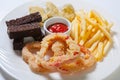 Fresh beer snacks assortment on a white plate. French fries, croutons and zucchini and sweet pepper Royalty Free Stock Photo