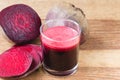 Fresh beet juice in glass and sliced beetroot on wooden table. Royalty Free Stock Photo