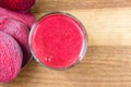 Fresh beet juice in glass and sliced beetroot on wooden table, top view. Royalty Free Stock Photo