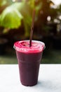 Fresh beet juice in glass on the table with green nature background Royalty Free Stock Photo