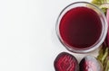 Fresh beetroot juice in glass with sliced beets and leaves on white background Royalty Free Stock Photo