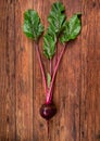 Fresh beetroot with leaves on wooden table