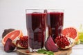 Fresh beetroot smoothie in glasses, grapefruit, beet and pomegranate on white wooden table Royalty Free Stock Photo