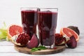 Fresh beetroot smoothie in glasses, grapefruit, beet and pomegranate on white wooden table Royalty Free Stock Photo