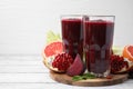 Fresh beetroot smoothie in glasses, grapefruit, beet and pomegranate on white wooden table. Space for text Royalty Free Stock Photo