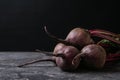 Fresh beets on grey table against black background. Space Royalty Free Stock Photo