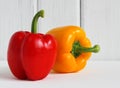 Fresh bell peppers against white wood background