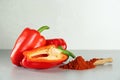 Fresh bell peppers and scoop of paprika powder on white table Royalty Free Stock Photo