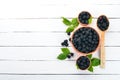 Fresh berries blackberries. On a black wooden background. Top view.