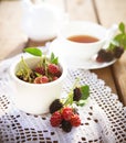 Fresh berries and cup of tea on table Royalty Free Stock Photo