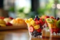 Fresh berries and pieces of fruit in a plastic glass to take away as a snack. Mango, Strawbery, blackberries in cup