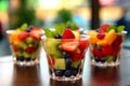 Fresh berries and pieces of fruit in a plastic glass to take away as a snack. Mango, Strawbery, blackberries in cup