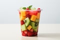 Fresh berries raspberry, strawberry, watermelon and pieces of fruits kiwi, mango, in plastic glass to take away as snack