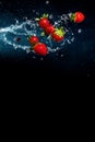 Fresh berries in splashes of water on black background. Juicy strawberries and blueberries Royalty Free Stock Photo