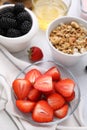 Fresh berries and tasty oatmeal on white tiled table. Healthy breakfast Royalty Free Stock Photo