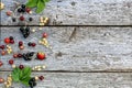 Fresh berries of white, black, currant, cherry, gooseberry and strawberry lie on the table in a scatter. Texture