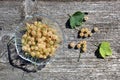 Fresh berries of white currant lie on a glass plate and are scattered near it.