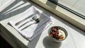 Fresh berries and yogurt presented elegantly on a windowsill during morning hours in a modern dining space Royalty Free Stock Photo