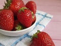 Fresh berry closeup organic strawberry natural health harvest summer dish towel on a pink wooden background Royalty Free Stock Photo