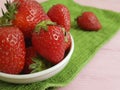 Fresh berry organic strawberry natural harvest summer dish towel on a pink wooden background Royalty Free Stock Photo