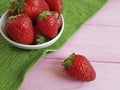 Fresh berry organic strawberry natural health harvest summer dish towel on a pink wooden background Royalty Free Stock Photo